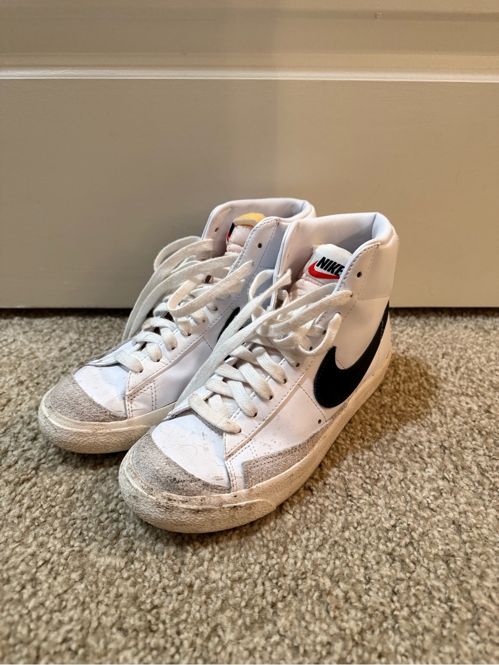 Nike White High-Top Sneakers with Black Swoosh